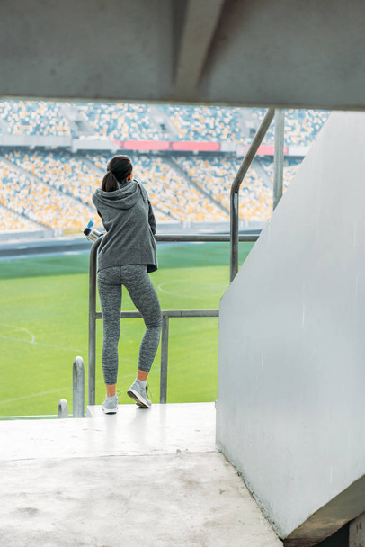 sportswoman at handrail on stadium  - Фото, изображение