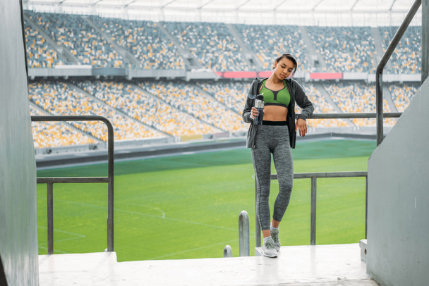 sportswoman at handrail on stadium  - Fotó, kép