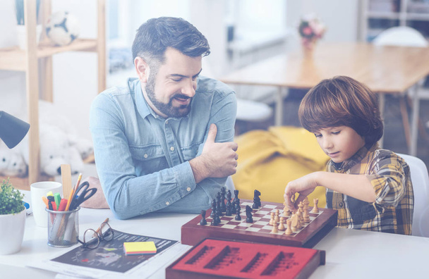 Cute boy playing chess with his father - Photo, Image