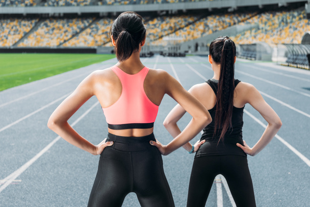 Sportswomen exercising on stadium  - Photo, Image