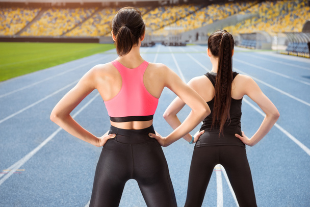 Sportswomen exercising on stadium  - Photo, Image