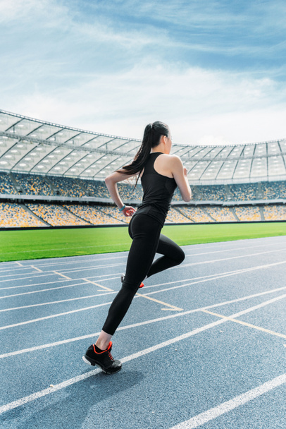 Sportswoman running on stadium  - Photo, Image