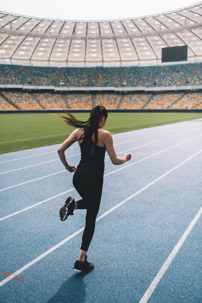 Sportswoman running on stadium  - Photo, Image