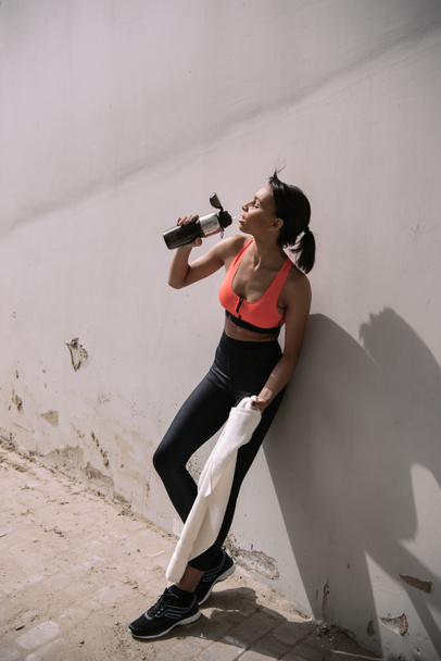 Sportswoman drinking water  - Photo, Image