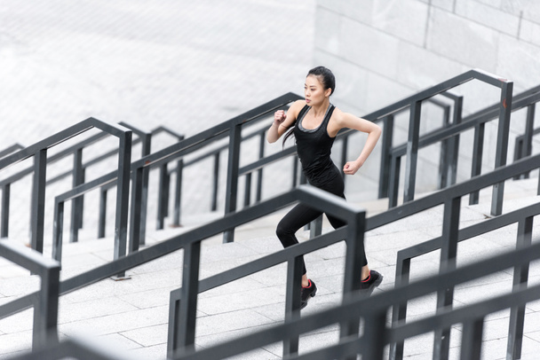 Sportswoman training on stadium stairs  - Fotografie, Obrázek