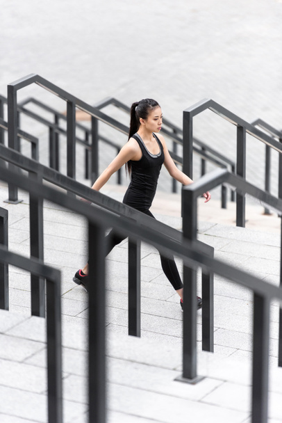 Sportswoman training on stadium stairs  - Foto, imagen