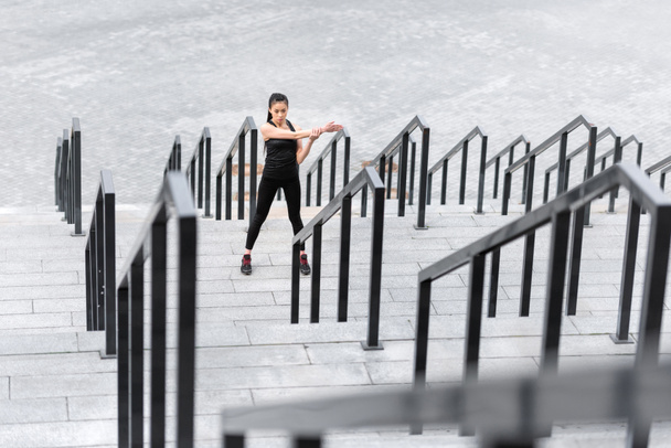 Sportswoman training on stadium stairs  - Фото, изображение