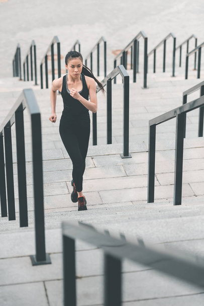Sportswoman training on stadium stairs  - Фото, зображення