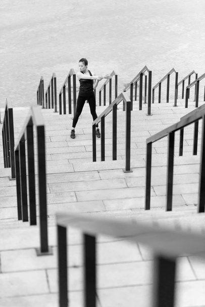 Sportswoman training on stadium stairs  - Foto, Imagen