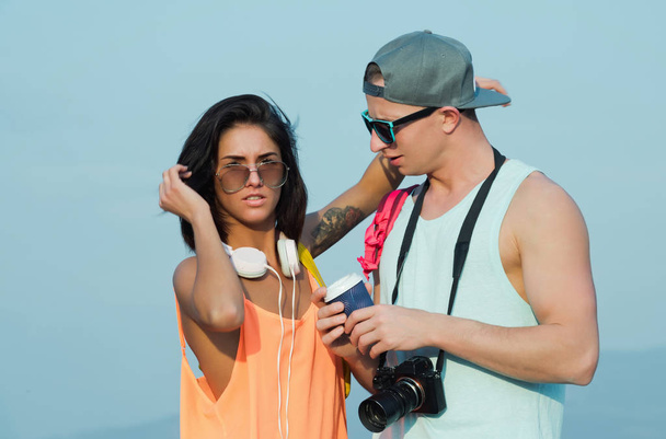 Sexy couple in stylish clothes and sunglasses on blue sky - Фото, изображение