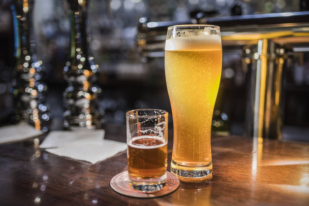 Beer glasses with beer on the bar 4 - 写真・画像