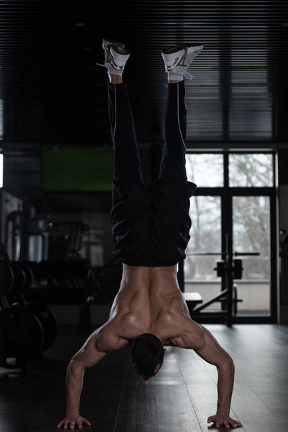 Athlete Doing Extreme Push Ups On Floor Handstand - Photo, Image