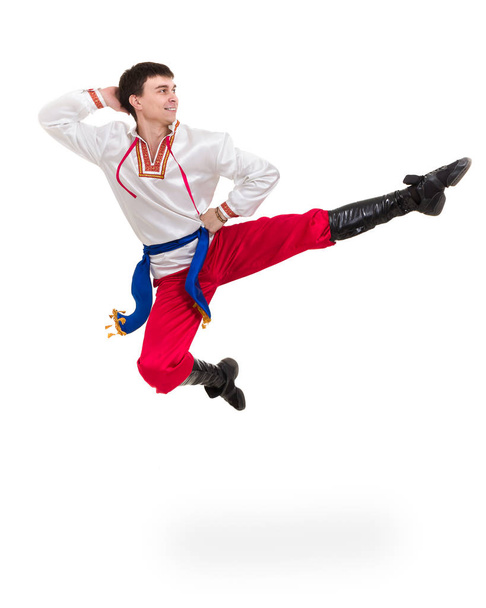 young man wearing a folk costume jumping against isolated white with copyspace - Foto, Bild