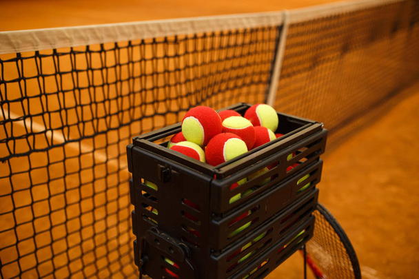 a lot of tennis balls to basket balls, tennis court . Grid for tennis - Valokuva, kuva