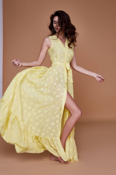 Sexy beauty woman pretty face tan skin wear yellow silk dress lo - Foto, Imagen