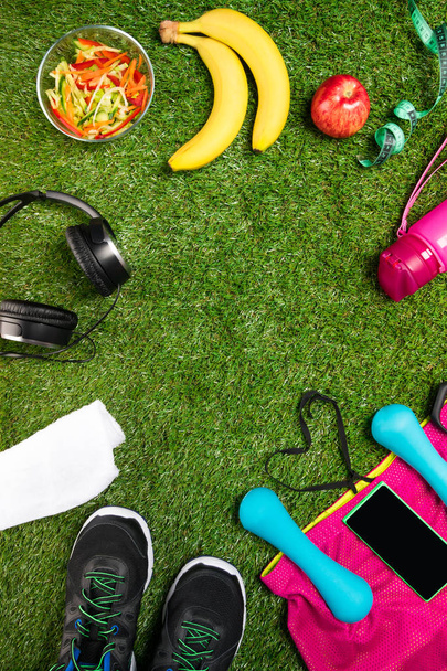 Sports nutrition set and things on a background of green grass - Φωτογραφία, εικόνα