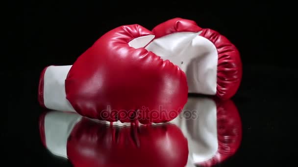 Czerwone rękawice bokserskie na powierzchni odblaskowej. - Materiał filmowy, wideo