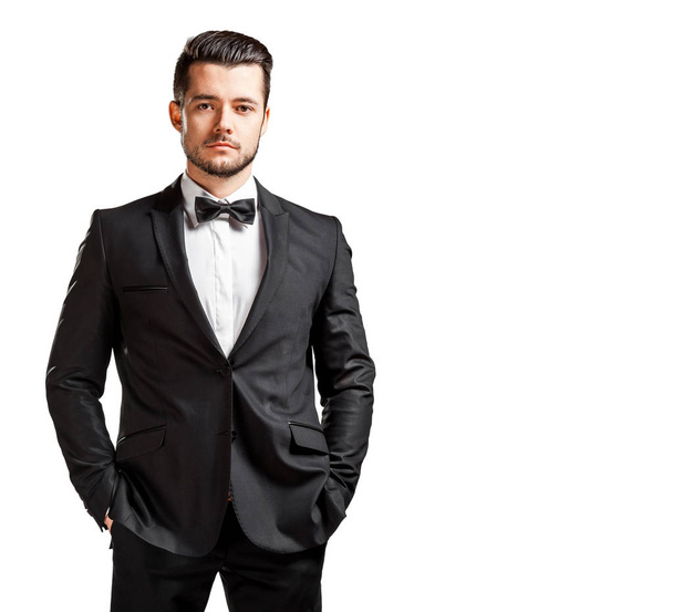 portrait of confident handsome man in black suit with bowtie - Photo, Image