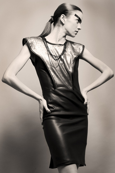 Portrait of beautiful fashion model in leather dress isolated - Fotografie, Obrázek