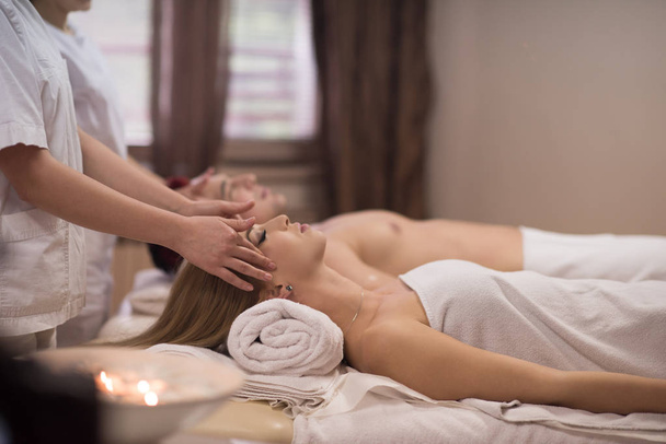 couple enjoying head massage at the spa - Photo, Image