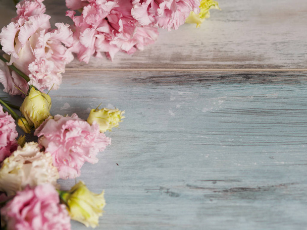 Beautiful spring blossom flowers background, on blue turquoise wooden background, place for text on the right. Springtime and nature concept - Photo, image