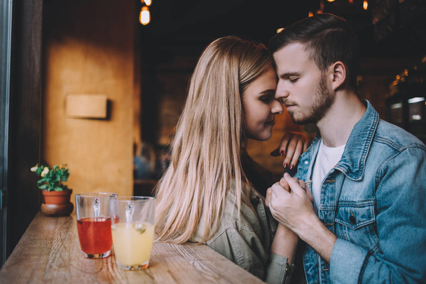 Portrait of beautiful young couple in love at a coffee shop. - Foto, Imagen