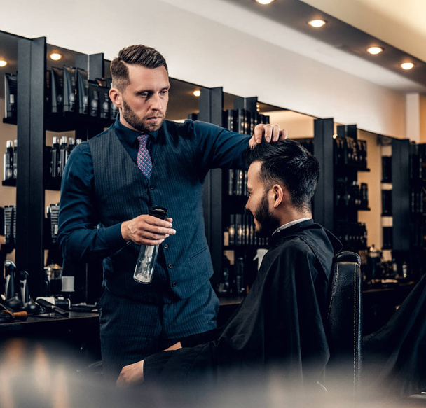 Stylish male hairdresser doing haircut  - Photo, Image