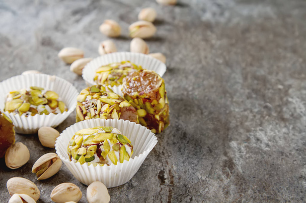 Eastern sweets. Turkish delight with pistachios in a vase. Dark  - Фото, изображение