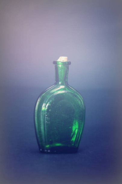 Old colourful bottles against a dark background - Fotó, kép