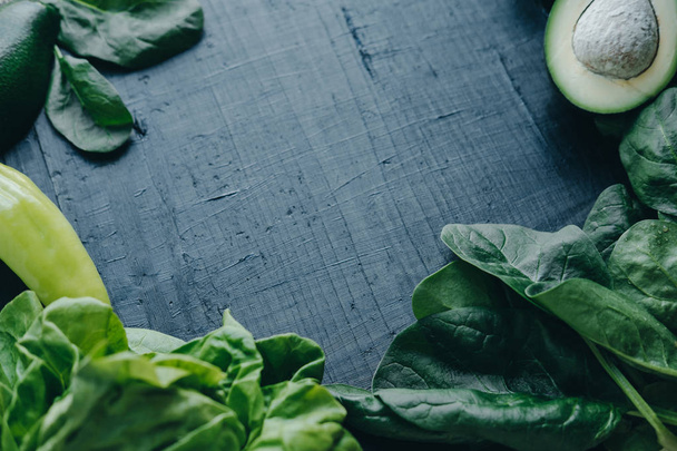 Fresh green vegetables on black board background: Spinach, avoca - Foto, imagen