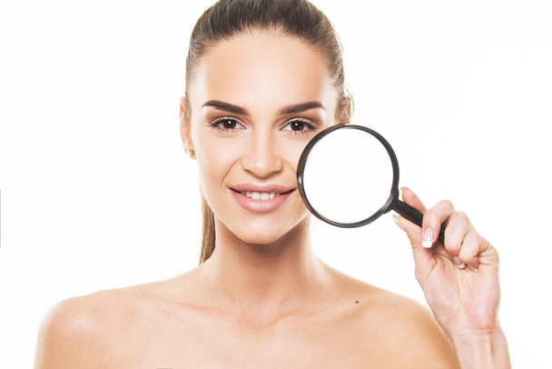beautiful girl with perfect skin holding magnifier close up face concept - Photo, Image
