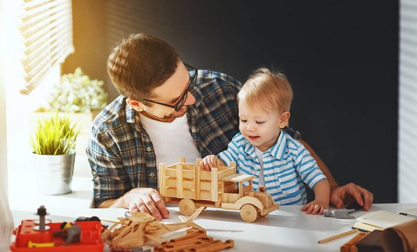 father and son toddler gather craft a car out of wood and play - Photo, Image