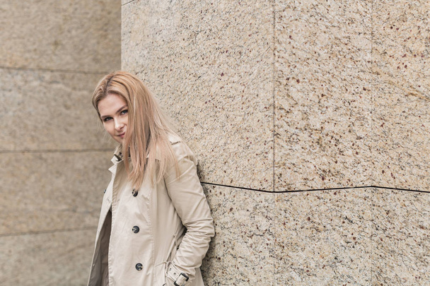 young woman in coat walks in the city - Zdjęcie, obraz
