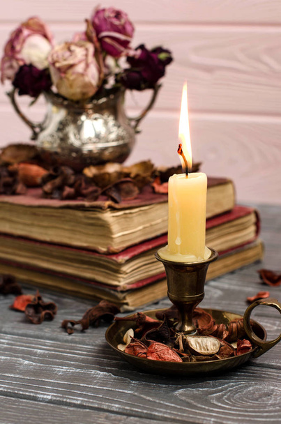 Candle in a candlestick. Vintage style. - Zdjęcie, obraz
