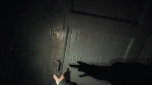 Point of view man with flashligh wandering in dark corridor opens door - Footage, Video