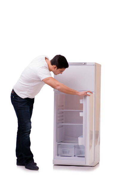 Homem procurando comida na geladeira vazia
 - Foto, Imagem