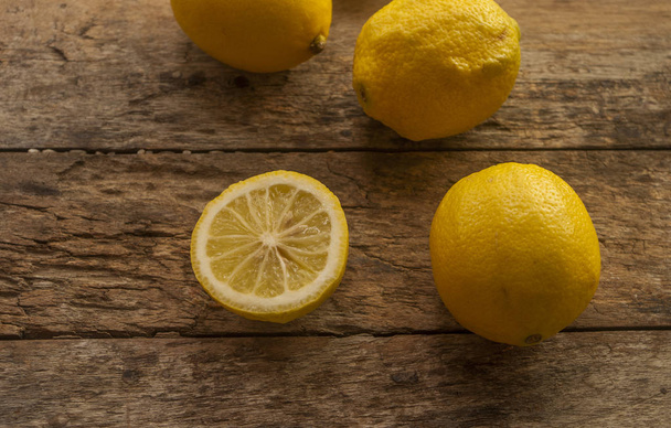 fresh lemon cut on wooden background - Fotografie, Obrázek