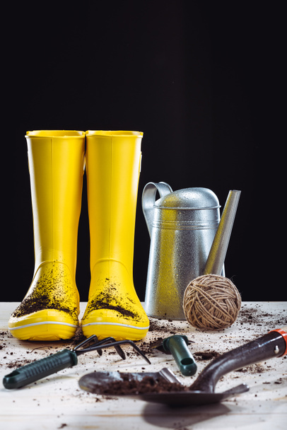 Rubber boots and garden tools  - Фото, изображение