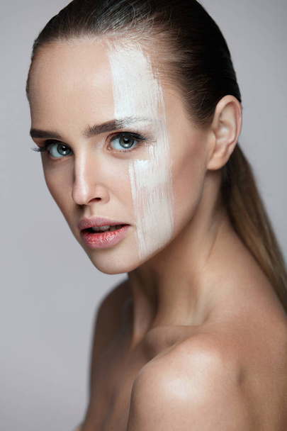 Cosmetics. Sexy Woman With Cream Mask Across Face. Skin Care - Zdjęcie, obraz