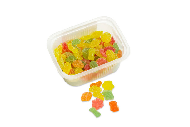 Caramelle di zucchero varicolore in piccoli contenitori di plastica
 - Foto, immagini