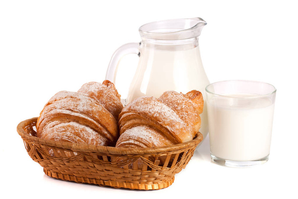 Jug and glass of milk with croissant isolated on white background - Photo, Image