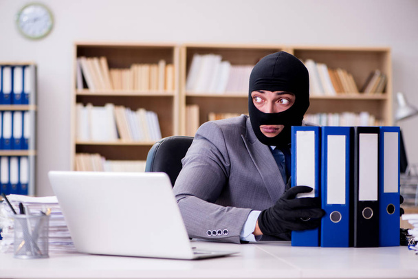 Criminal businessman with balaclava in office - Photo, Image