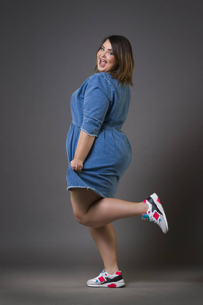 Plus size fashion model in casual clothes, fat woman on gray background, overweight female body - Fotografie, Obrázek