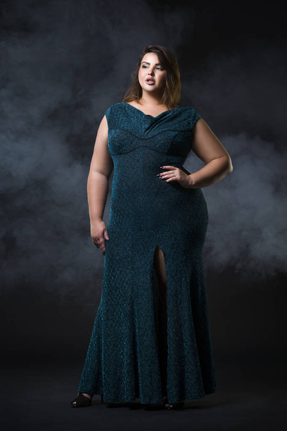 Plus size fashion model in green evening dress, fat woman on black background, overweight female body - Photo, Image