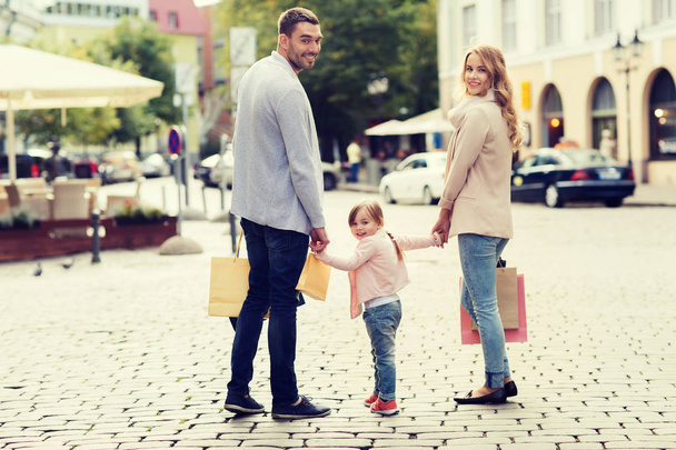 happy family with child and shopping bags in city - Фото, изображение