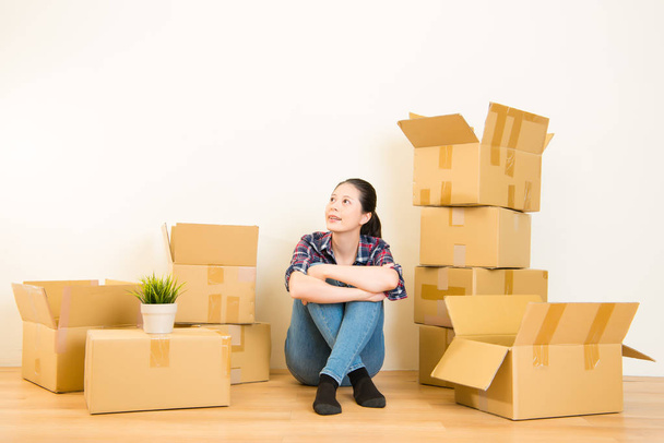 Young woman with boxes dreaming - Foto, imagen
