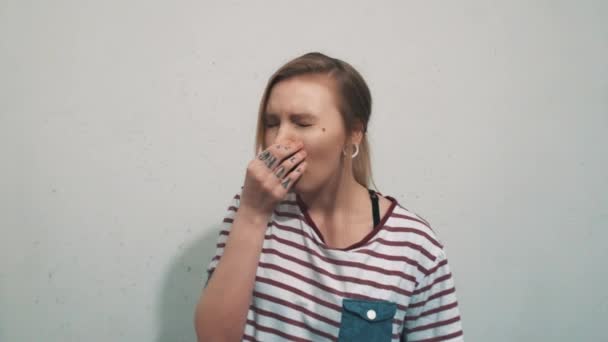 Pretty blonde woman in striped shirt, smells something bad and cover up nose - Footage, Video