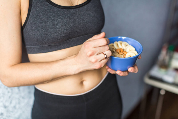Sports woman holding oatmeal in hands - Photo, Image