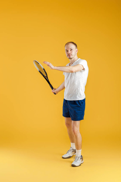 young tennis player plays tennis on yellow background - Fotó, kép