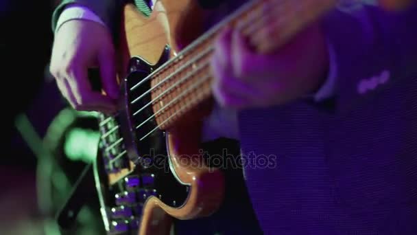 Bass Guitar close up. Man playing guitar at rock concert. 4k UHD video - Video
